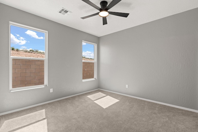 unfurnished room with carpet flooring and ceiling fan