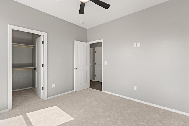 unfurnished bedroom featuring ceiling fan, a closet, and light colored carpet