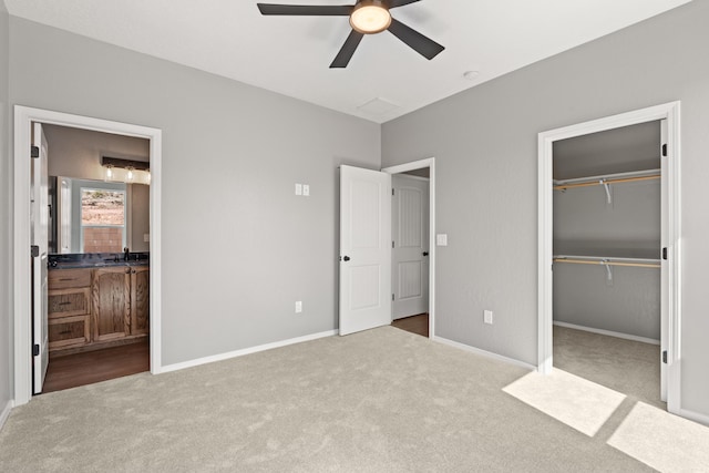 unfurnished bedroom with ceiling fan, a closet, light carpet, and sink