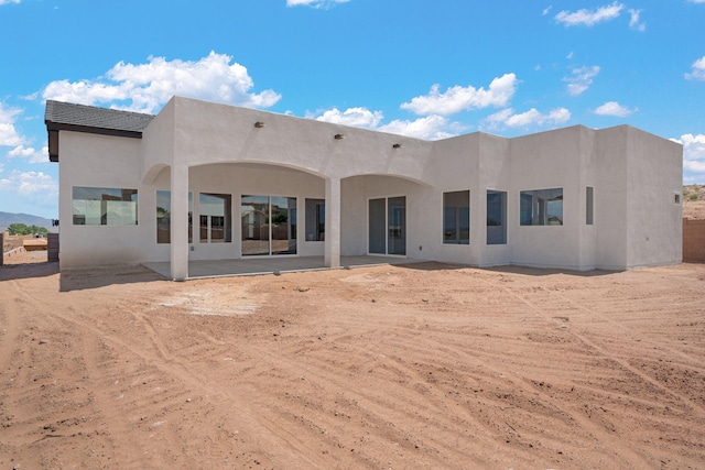 back of property with a patio