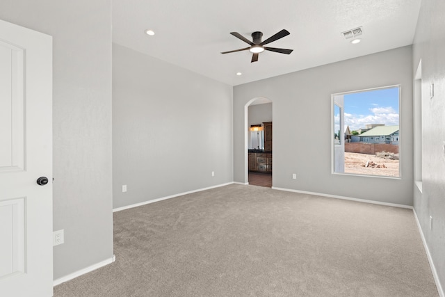 empty room featuring carpet flooring and ceiling fan