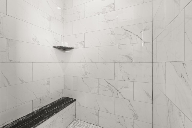 bathroom with a tile shower