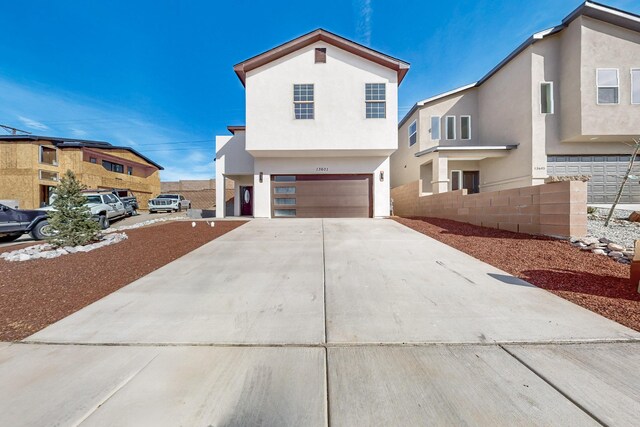 13601 Covered Wagon Ave SE, Albuquerque, NM 87123 - view of front of property featuring stucco siding, concrete driveway, and a garage