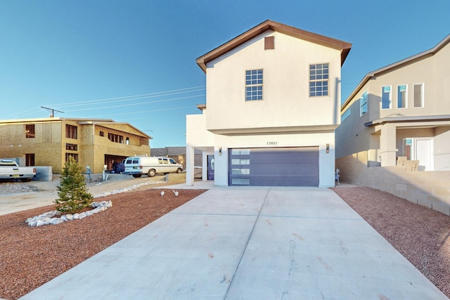 13601 Covered Wagon Ave SE, Albuquerque, NM 87123 - view of front of property featuring an attached garage, stucco siding, and concrete driveway