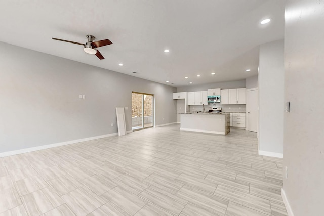 unfurnished living room featuring ceiling fan