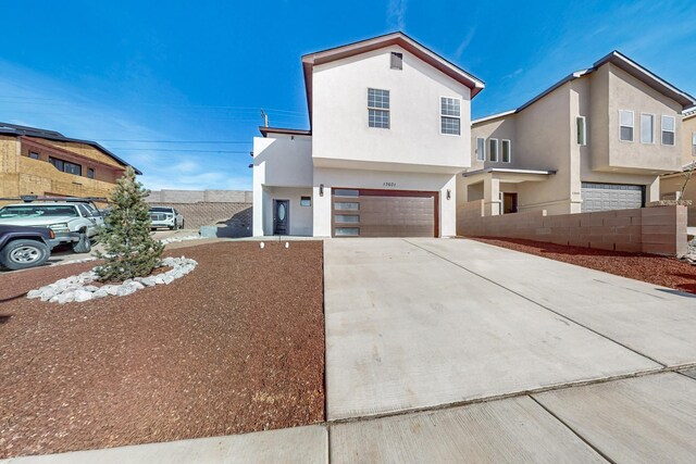 13601 Covered Wagon Ave SE, Albuquerque, NM 87123 - view of front of property featuring stucco siding, driveway, fence, and a garage