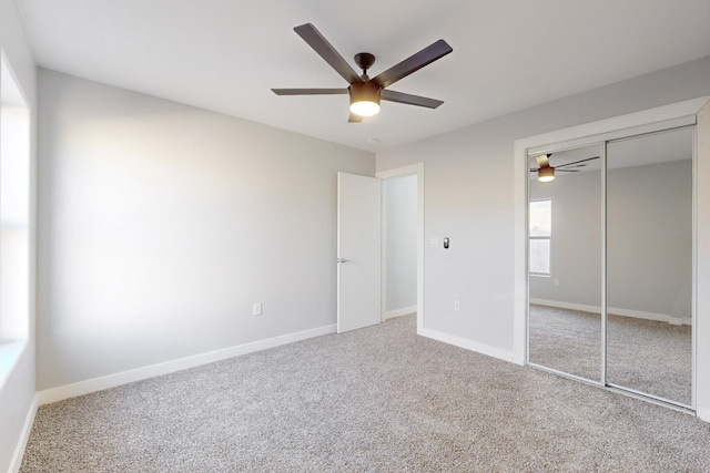 unfurnished bedroom with a closet, ceiling fan, and carpet