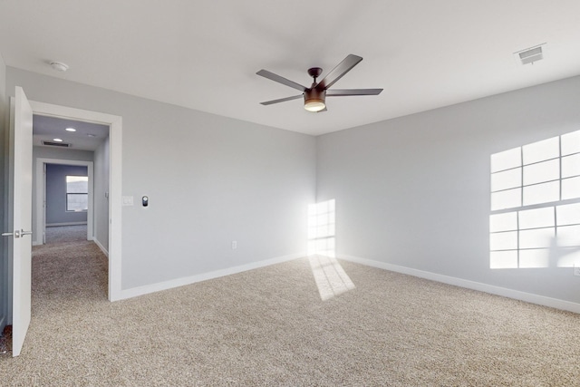 empty room with ceiling fan and carpet