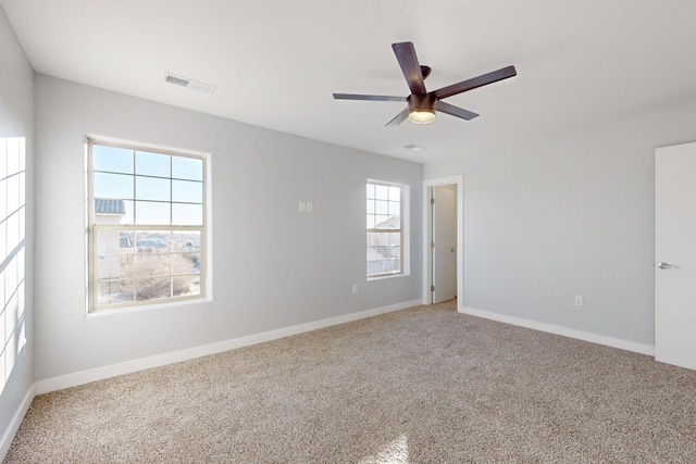 spare room featuring ceiling fan and carpet