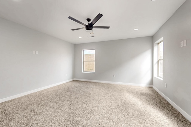 unfurnished room featuring a wealth of natural light and ceiling fan