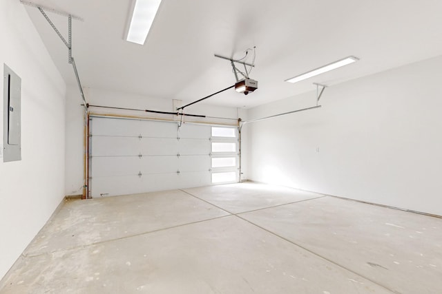 garage with a garage door opener and electric panel