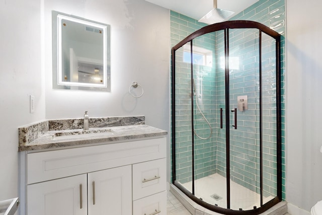 bathroom featuring vanity and a shower with shower door