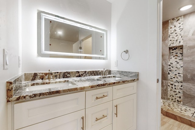 bathroom featuring vanity and a tile shower