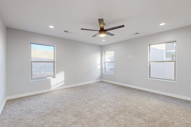 unfurnished room with ceiling fan and carpet floors