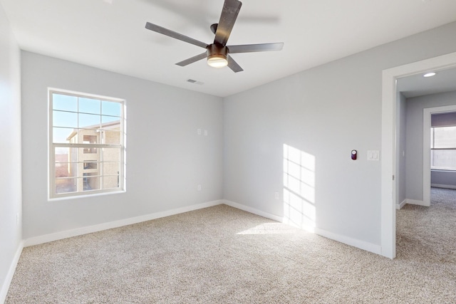 carpeted empty room featuring ceiling fan