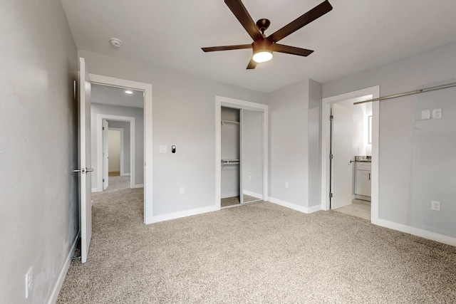 unfurnished bedroom with ensuite bathroom, light colored carpet, ceiling fan, and a closet