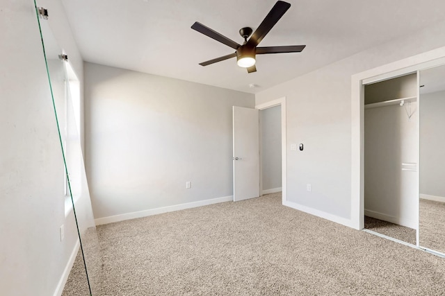 unfurnished bedroom with ceiling fan, a closet, and light carpet