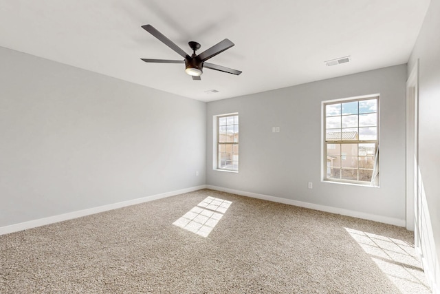 carpeted empty room featuring ceiling fan