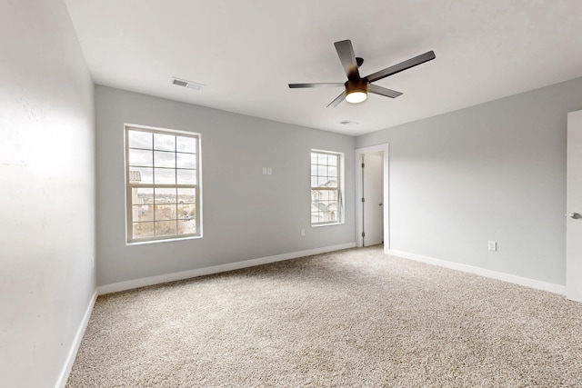 spare room featuring carpet flooring and ceiling fan