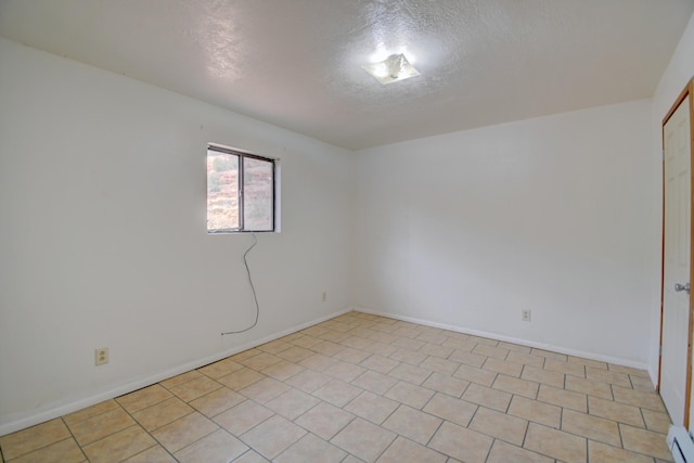 empty room featuring a baseboard radiator and a textured ceiling