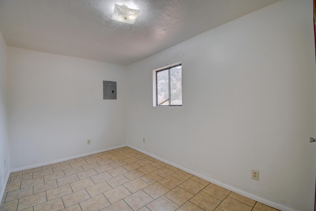 spare room featuring a textured ceiling and electric panel