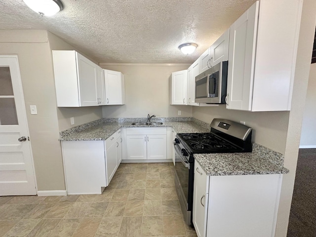 kitchen with white cabinets, sink, a textured ceiling, appliances with stainless steel finishes, and light stone counters