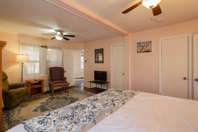 bedroom with hardwood / wood-style flooring and ceiling fan