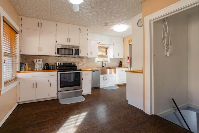 kitchen featuring white cabinetry, appliances with stainless steel finishes, sink, and decorative backsplash