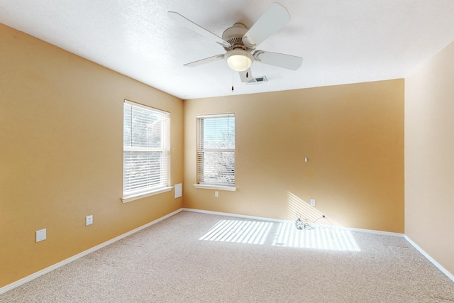 empty room featuring carpet floors and ceiling fan