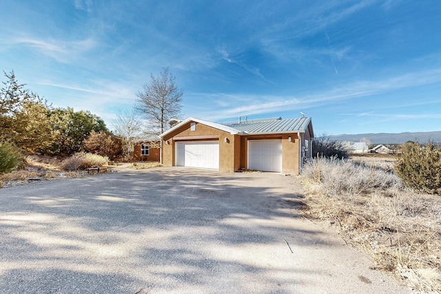 view of home's exterior featuring a mountain view and a garage