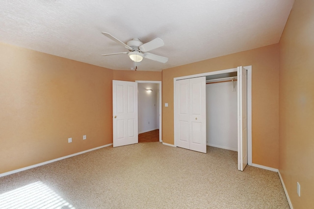 unfurnished bedroom featuring carpet flooring, ceiling fan, and a closet