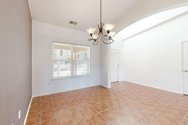 unfurnished room featuring a notable chandelier