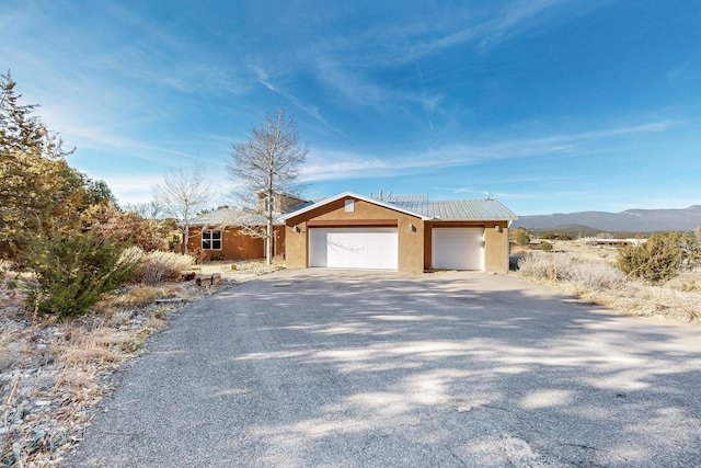 ranch-style house featuring a mountain view and a garage