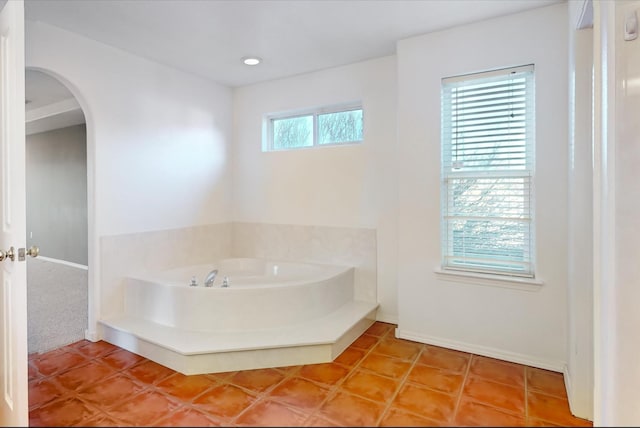 bathroom featuring a tub and tile patterned flooring