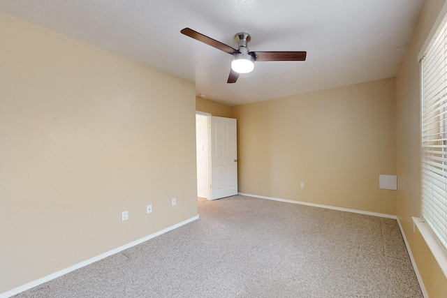 spare room featuring ceiling fan and light colored carpet