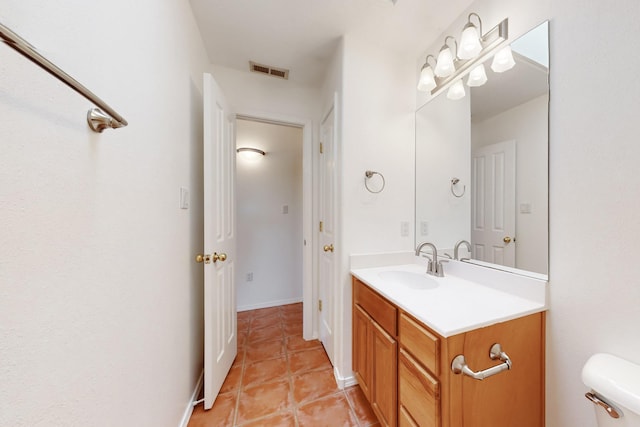 bathroom featuring tile patterned floors, vanity, and toilet