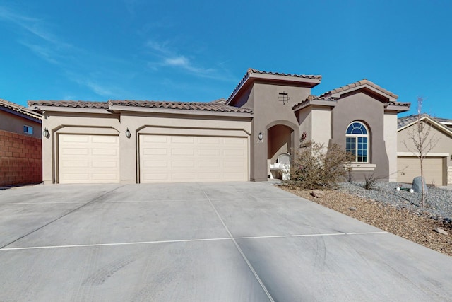 mediterranean / spanish home featuring a garage