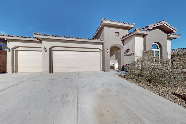 mediterranean / spanish home featuring a garage