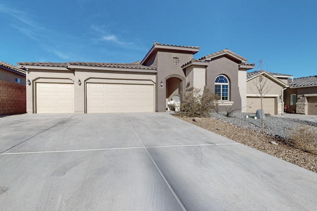 mediterranean / spanish-style home with a garage