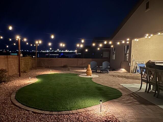 yard at night with a patio