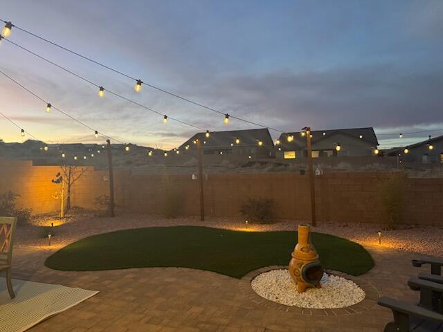 yard at dusk featuring a patio