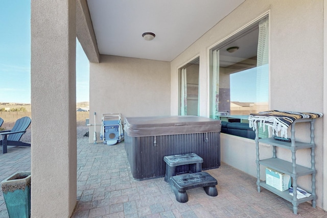 view of patio / terrace with a hot tub