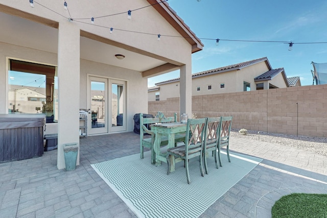 view of patio / terrace featuring french doors and a hot tub