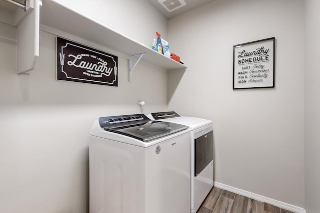 washroom featuring dark hardwood / wood-style floors and independent washer and dryer