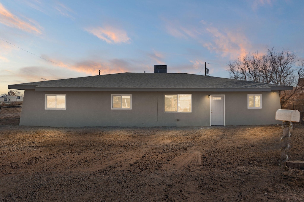 view of back house at dusk