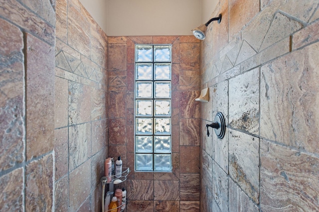 bathroom with tiled shower