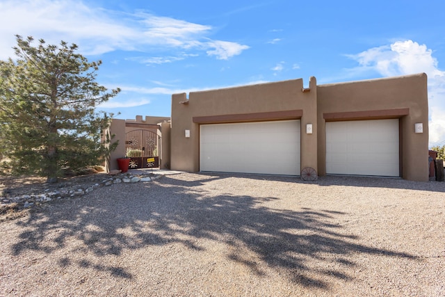 pueblo-style house with a garage