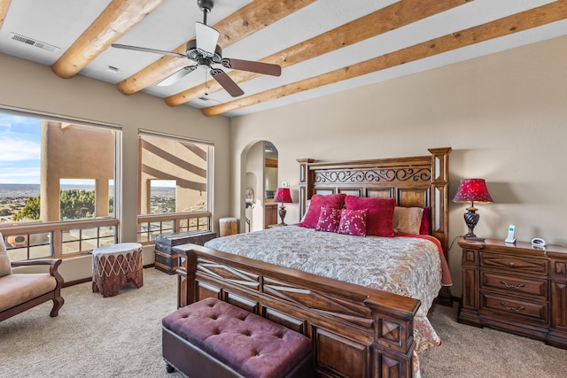 bedroom featuring light carpet, beam ceiling, and ceiling fan