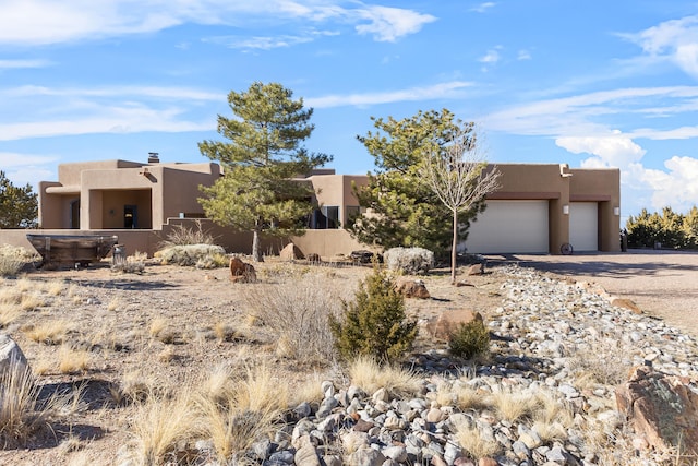 adobe home featuring a garage