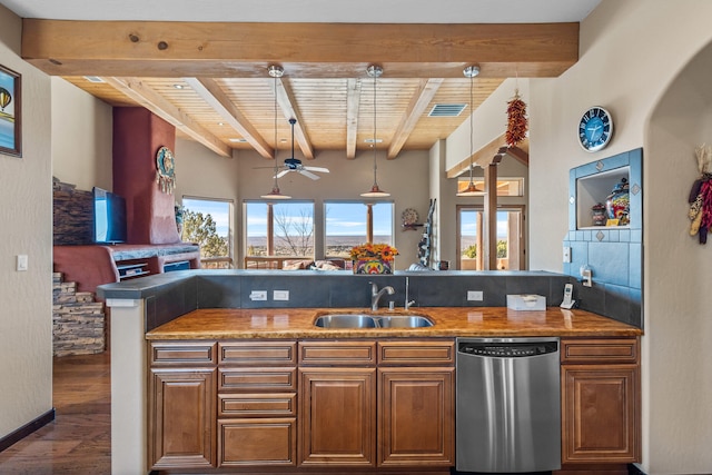 kitchen featuring stainless steel dishwasher, sink, beam ceiling, wooden ceiling, and hanging light fixtures